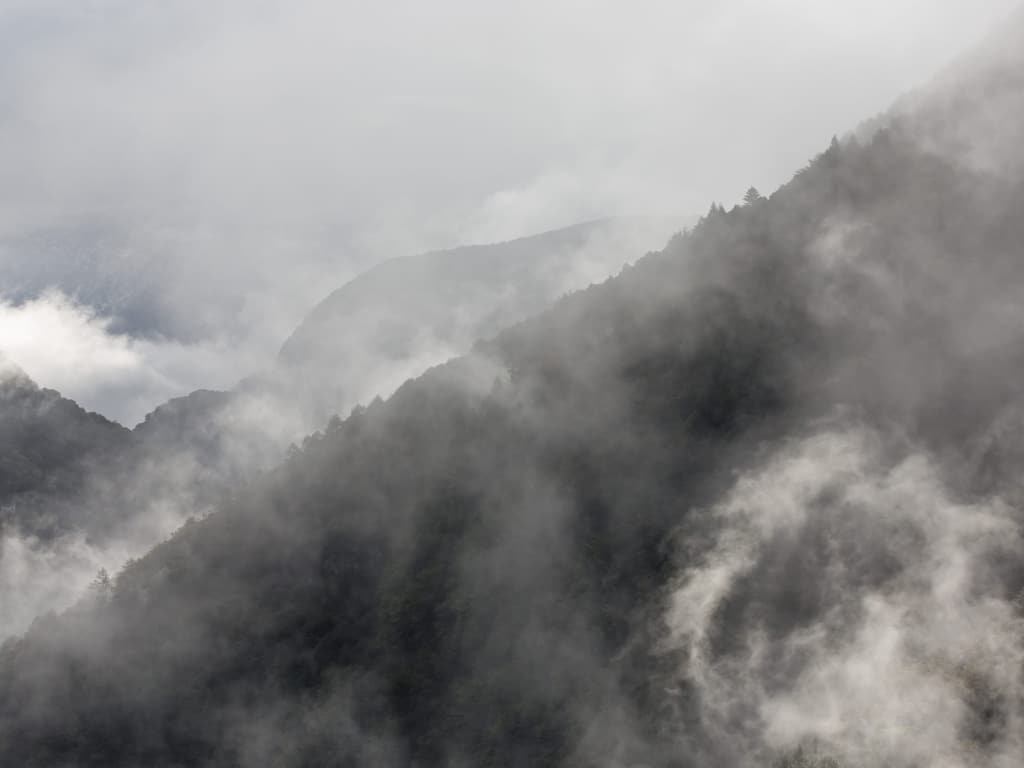 Nebelschwaden über den bewaldeten Hängen des Valle Onsernone im Tessin